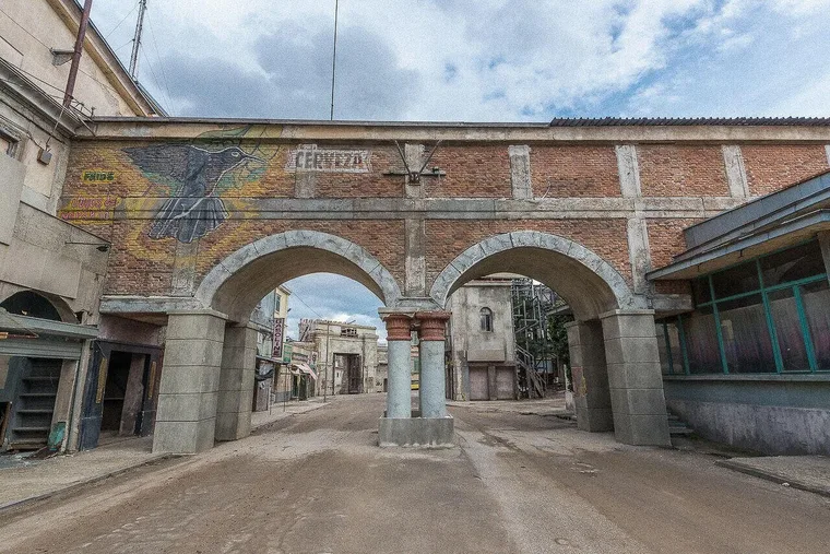 Standing street set near Sofia, brick arches over the roadway with painted wall signage