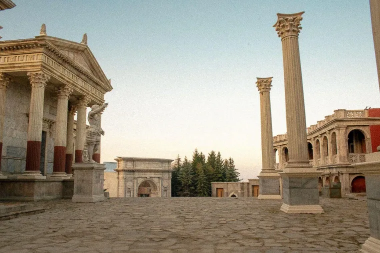 Ancient Rome backlot near Sofia, temple colonnade and triumphal arch at dusk