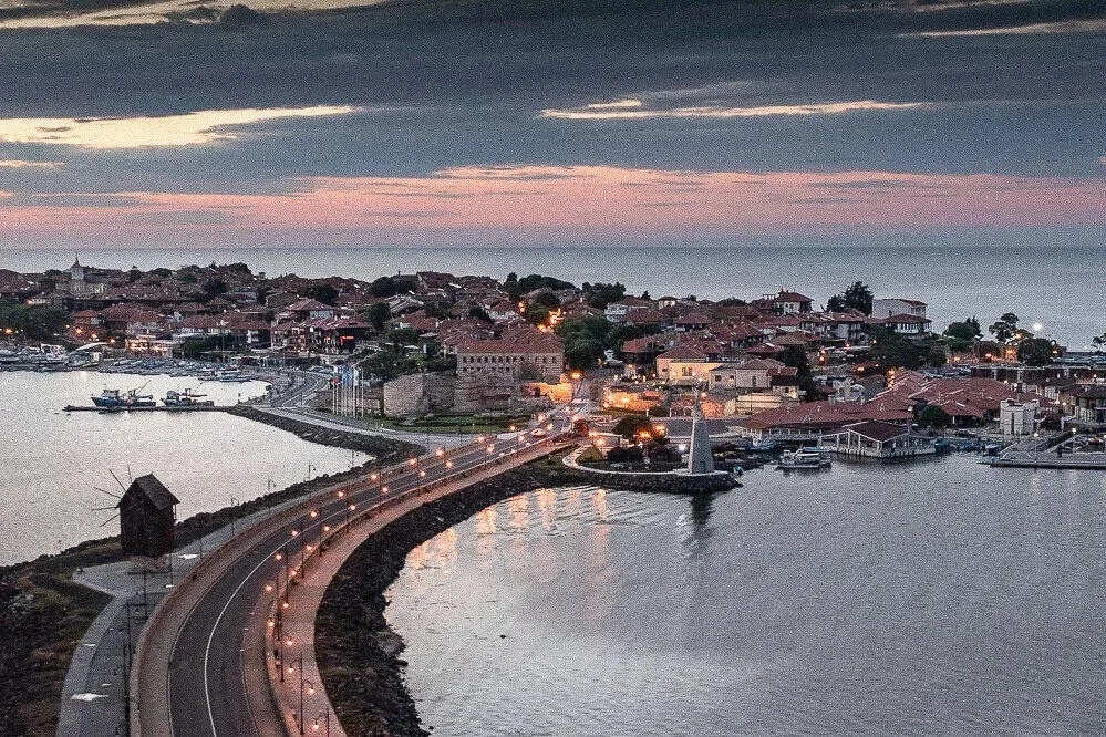 Coastal road curving into the old town of Nesebar on the Bulgarian Black Sea coast at dusk